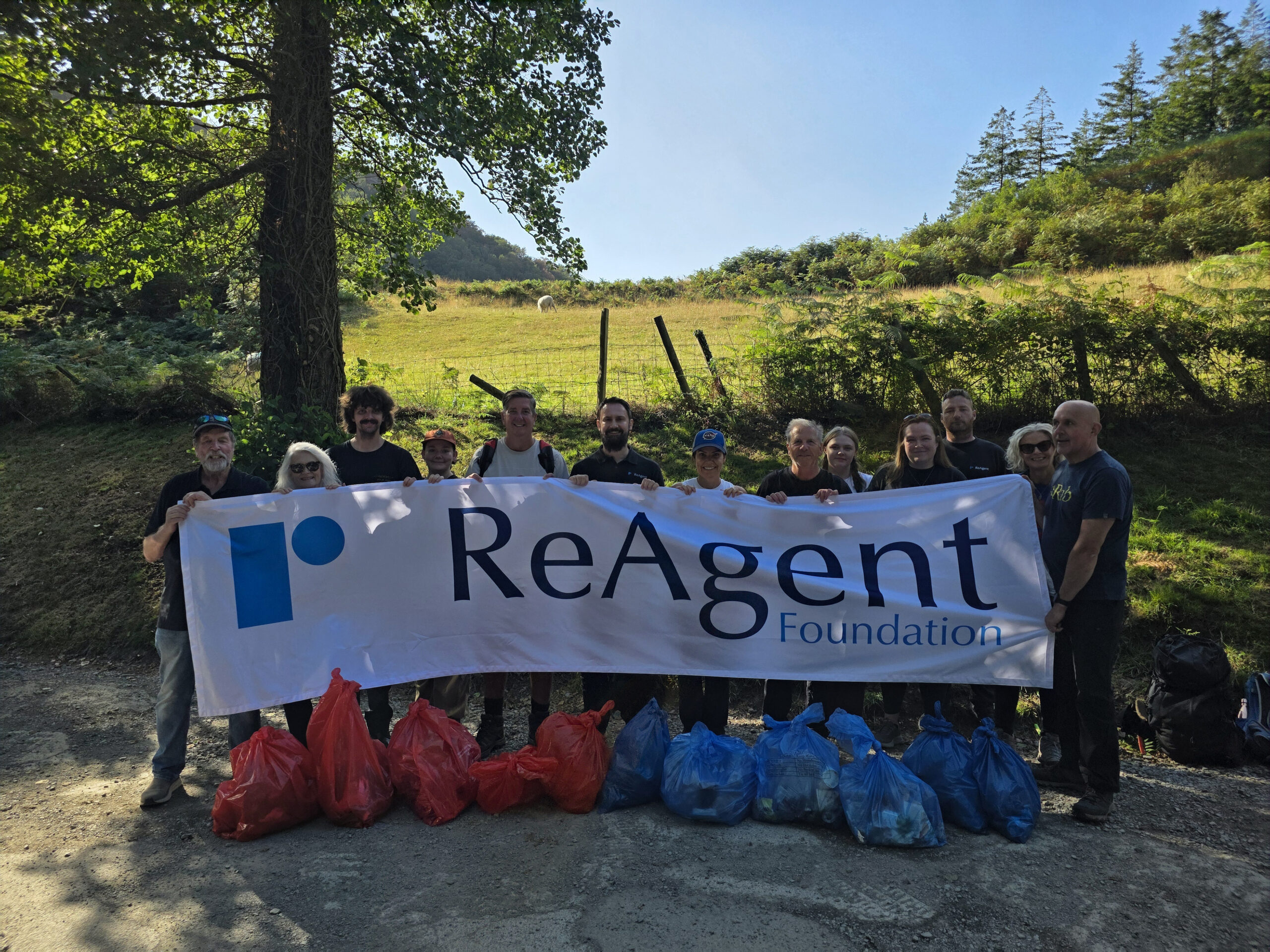 ReAgent Foundation team members holding banner during the Snowdonia Society volunteer day