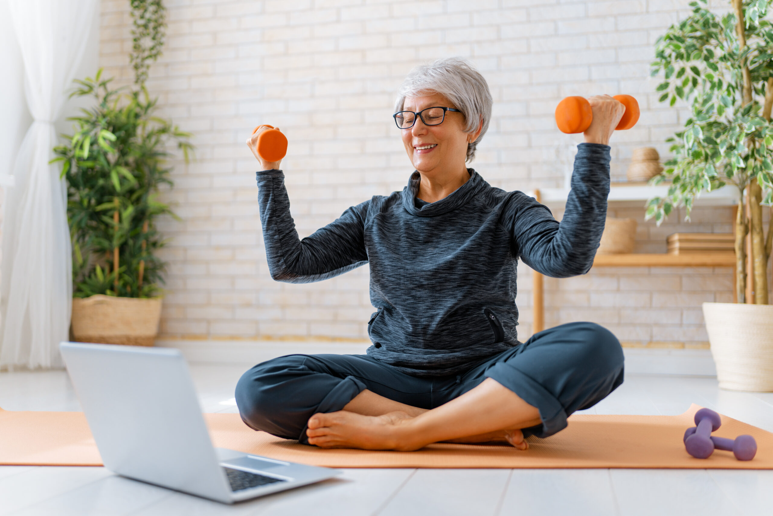 Photo of woman doing an online exercise class.